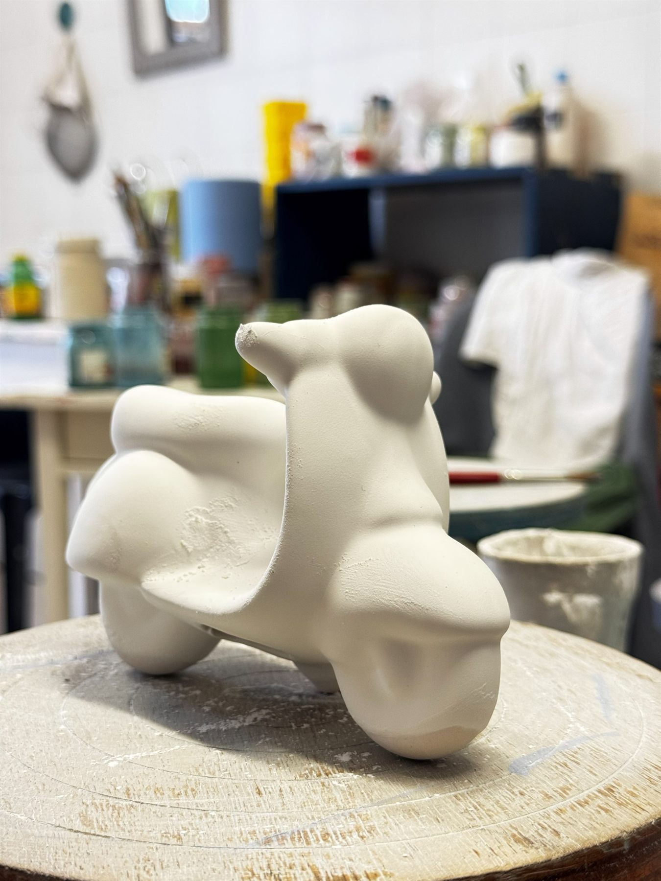 Hand-modelled ceramic Vespa photographed in raw clay before firing
