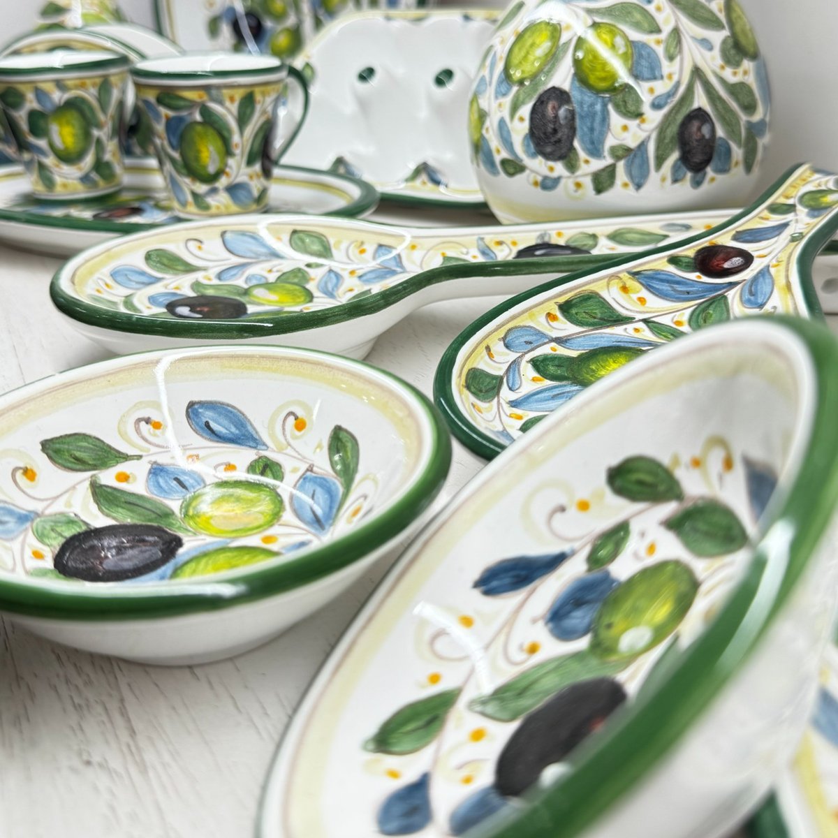 Olives line: plates and bowls with green and black olives