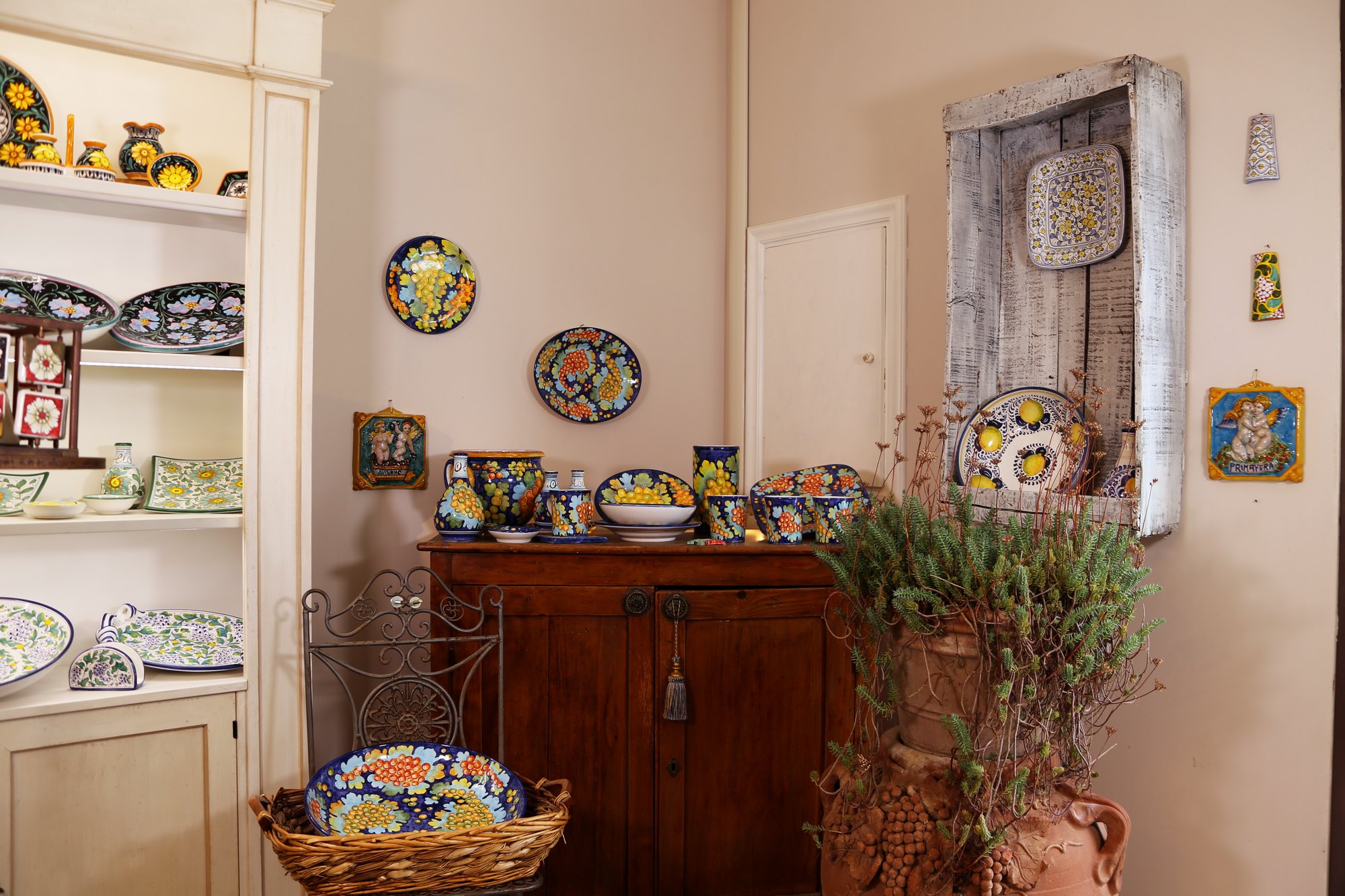 Corner of the workshop with a dresser, hand-painted ceramics and lavender