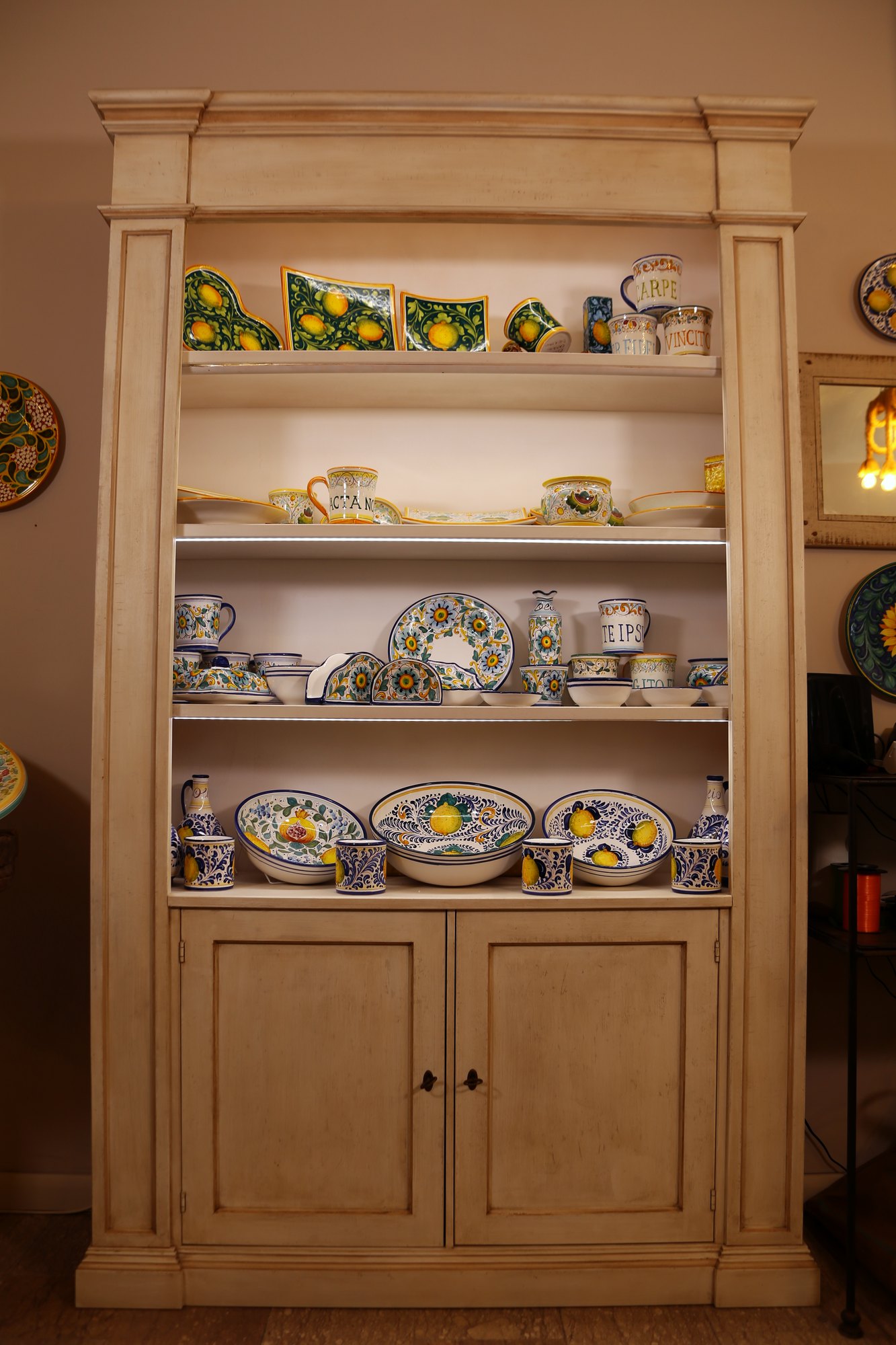 Pale dresser with hand-painted plates and bowls