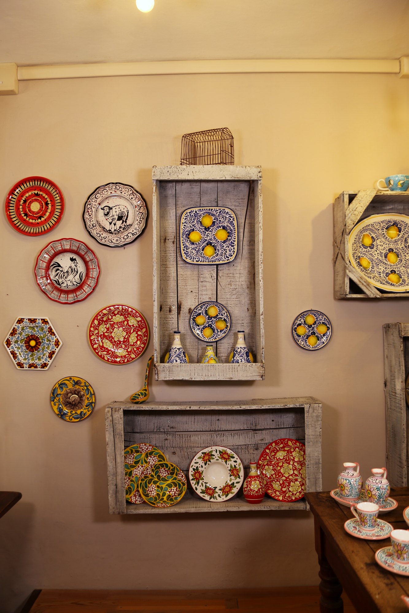 Workshop wall with hand-painted plates and wooden crates