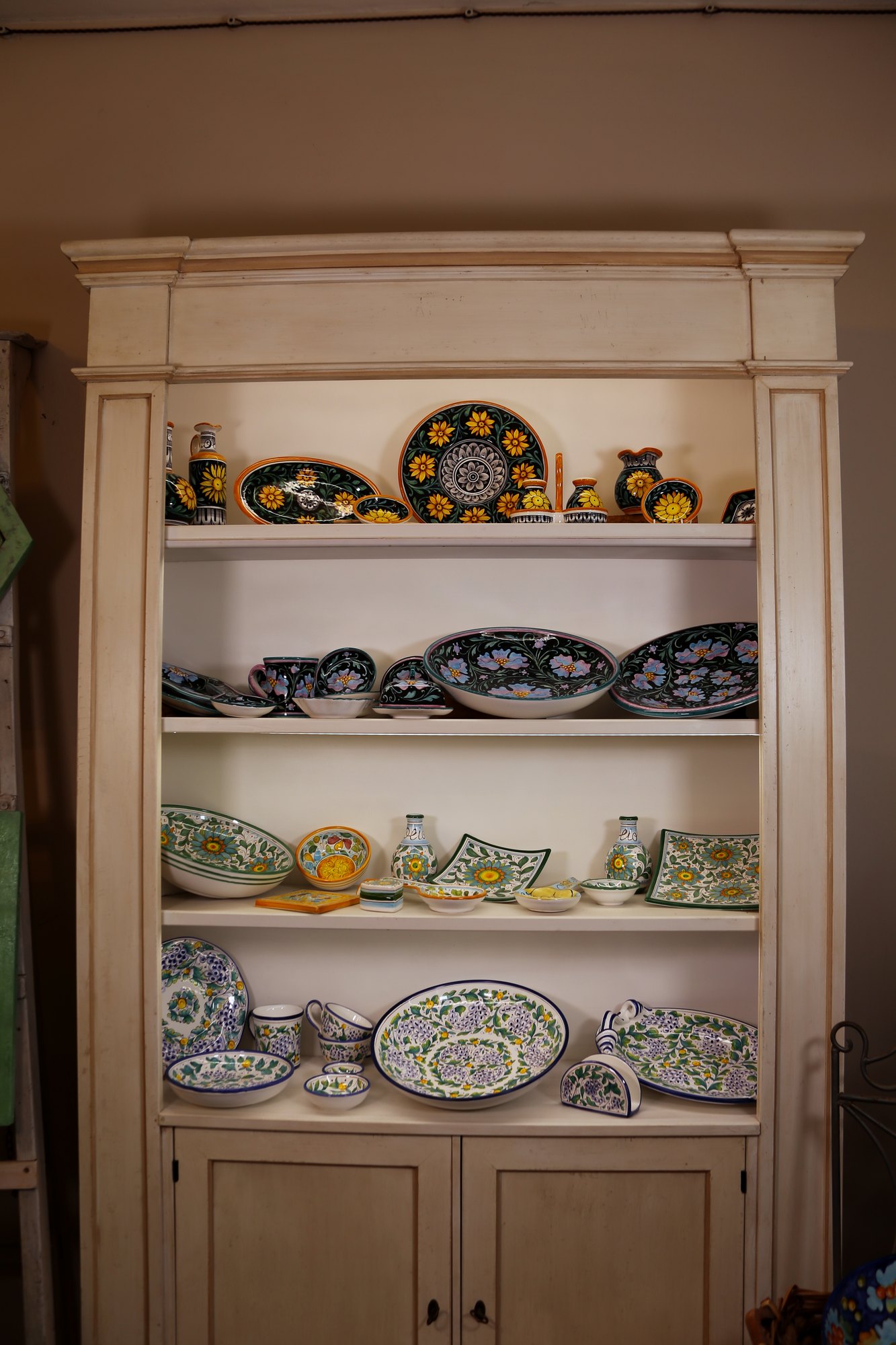 Dresser with a dinner set hand-painted in black and green