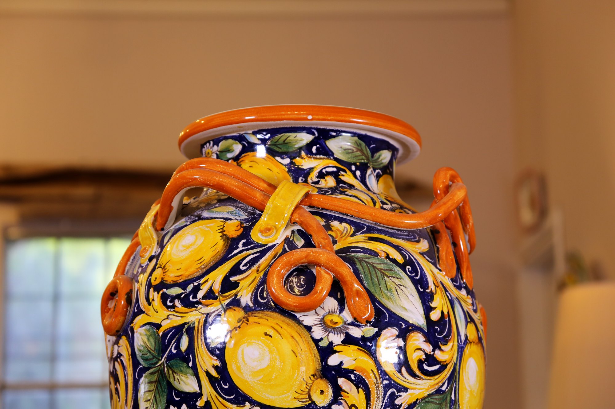 Detail of the lemon pattern and raised rope handles on a hand-painted Tuscan jar